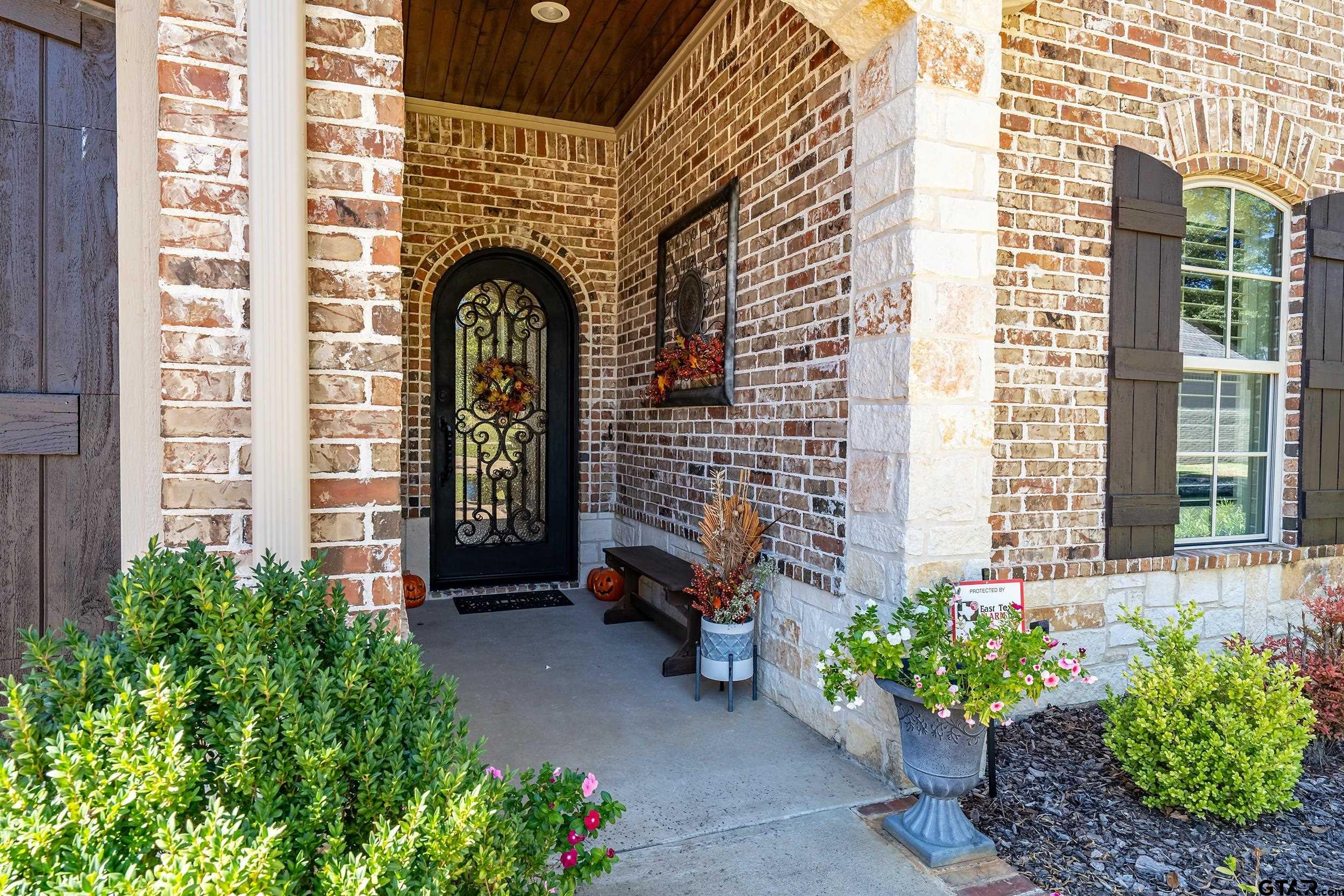 7311 Cross Road Tyler, TX 75703 - Photo 4 of 36 a front view of a house with a garden