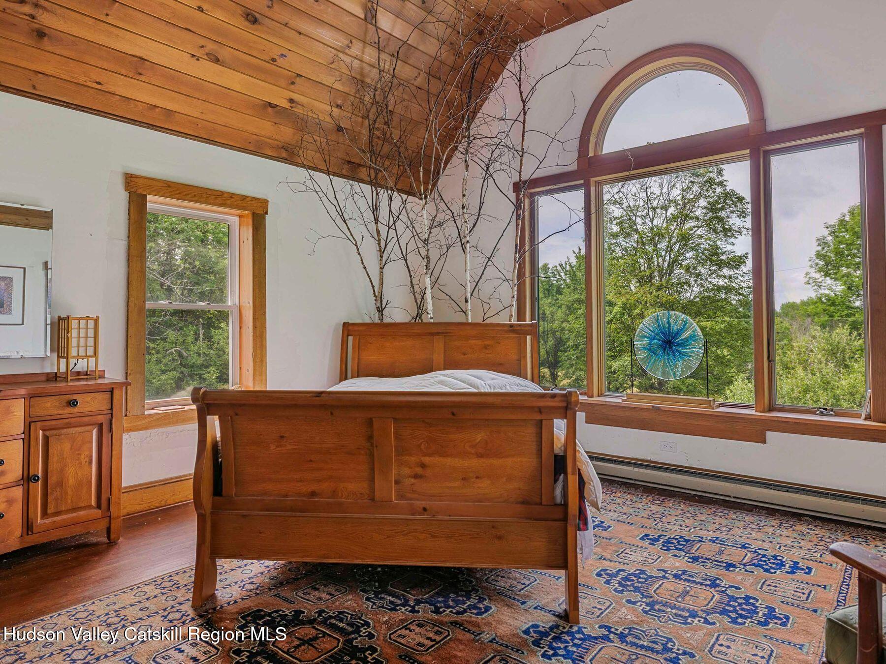 324 Schrader Road Ashland, NY 12468 - Photo 15 of 49 a bedroom with a bed and a large window