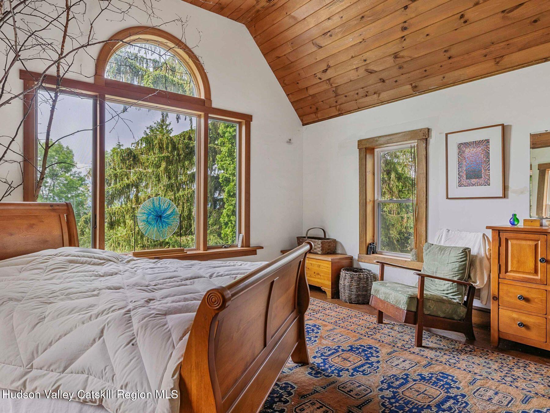 324 Schrader Road Ashland, NY 12468 - Photo 17 of 49 a bed sitting in a bedroom next to a window