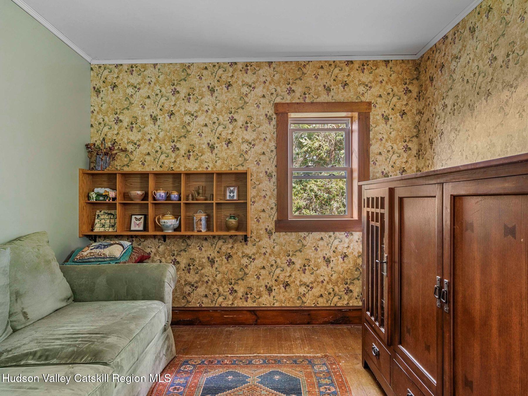 324 Schrader Road Ashland, NY 12468 - Photo 22 of 49 a living room with a couch and a dresser next to a window