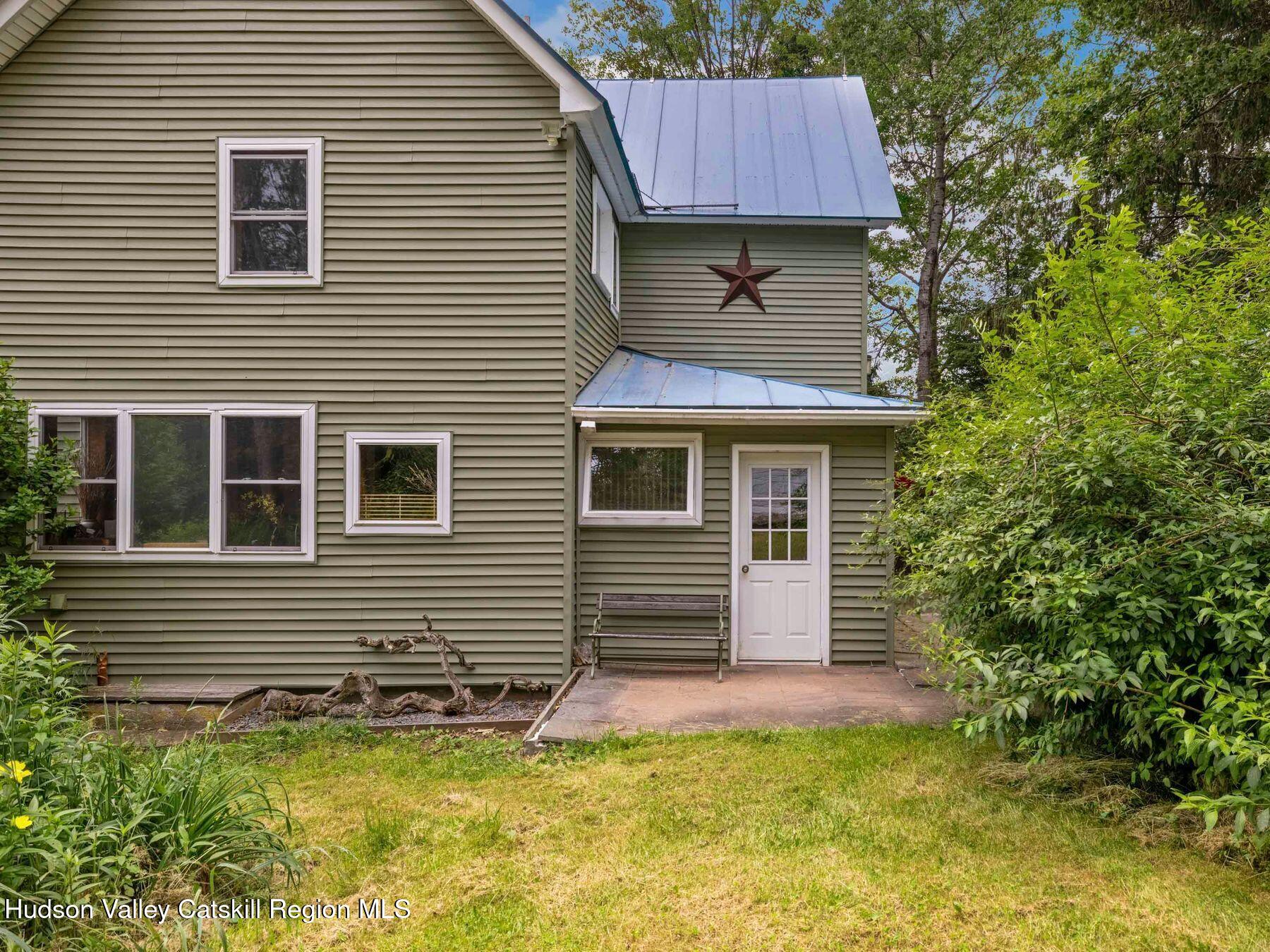 324 Schrader Road Ashland, NY 12468 - Photo 37 of 49 a view of a house with a yard and sitting area