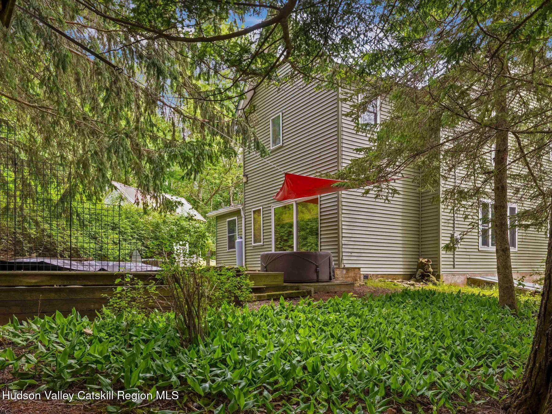324 Schrader Road Ashland, NY 12468 - Photo 41 of 49 a backyard of a house with lots of green space and fountain