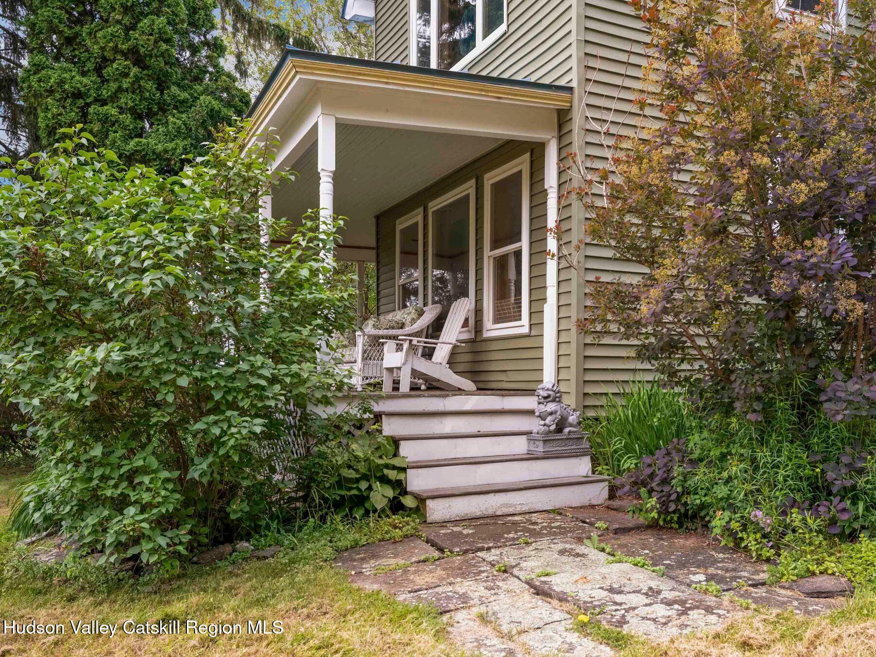 324 Schrader Road Ashland, NY 12468 - Photo 44 of 49 a view of a house with potted plants and a fountain