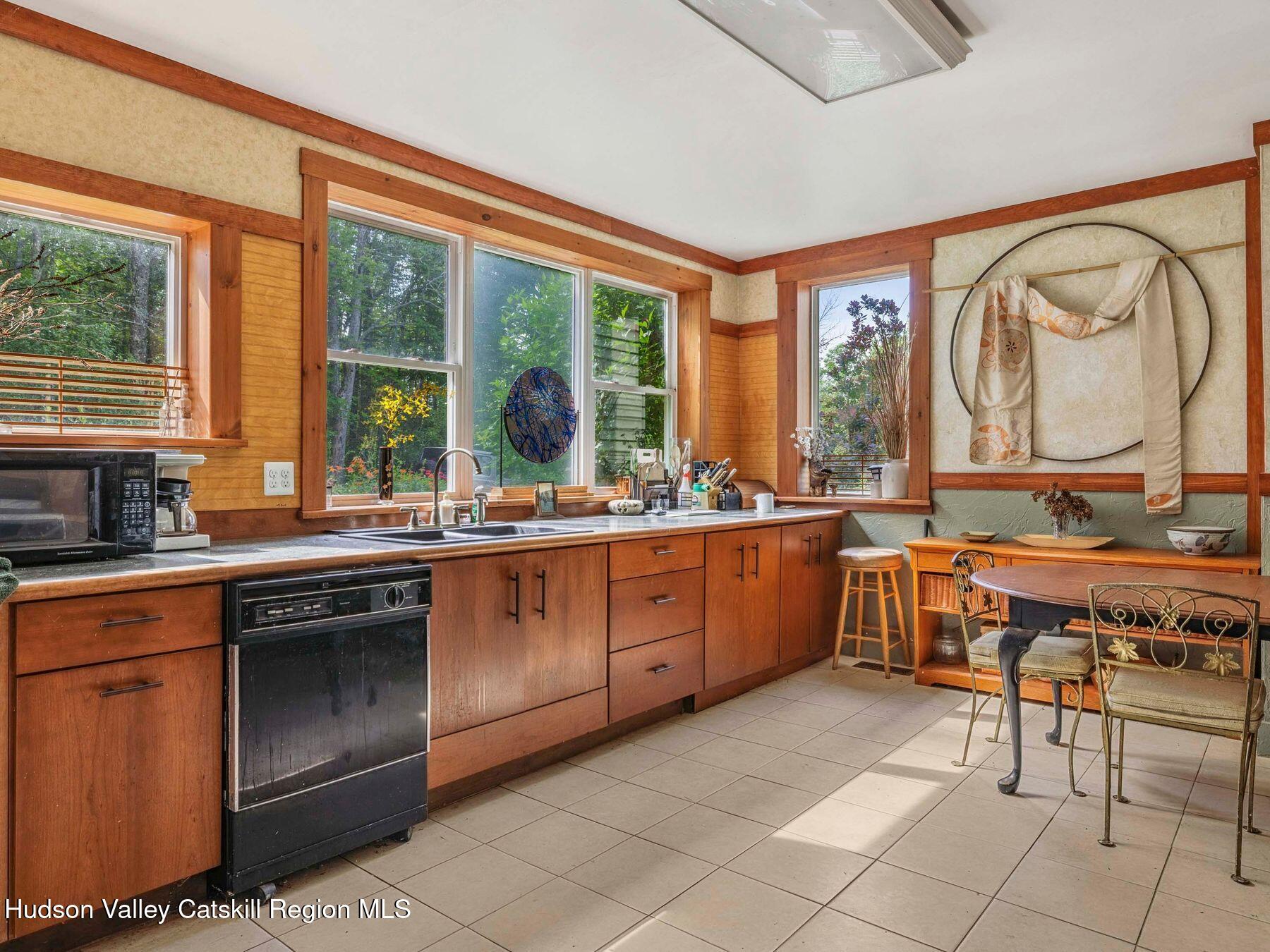 324 Schrader Road Ashland, NY 12468 - Photo 8 of 49 a kitchen with stainless steel appliances granite countertop a stove a sink and a microwave