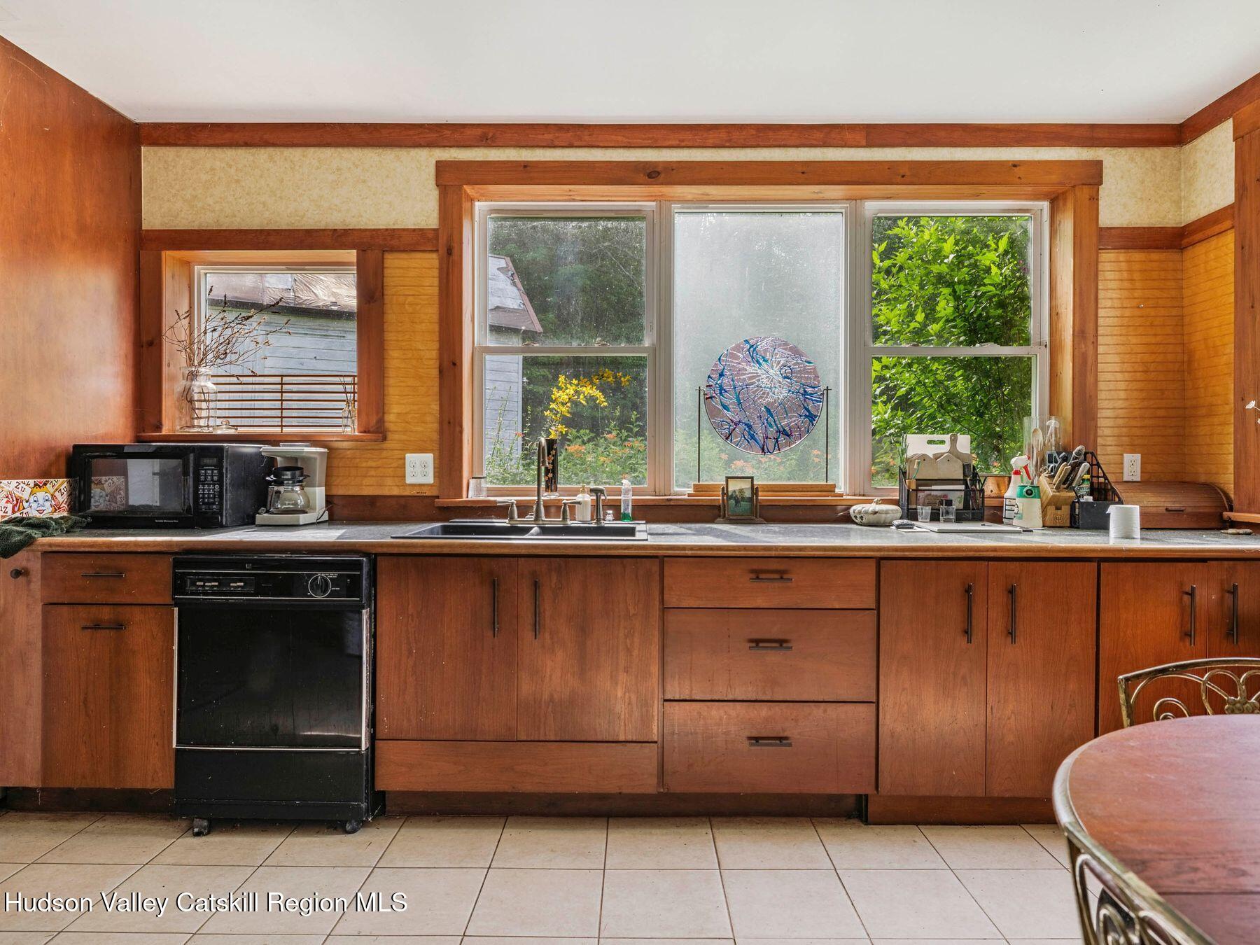 324 Schrader Road Ashland, NY 12468 - Photo 9 of 49 a kitchen with a sink window and cabinets