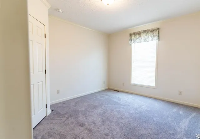 an empty room with a empty space and a window