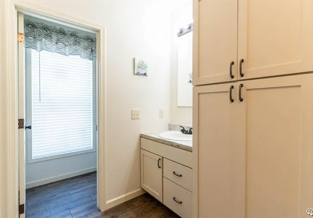 a bathroom with a double vanity sink a mirror and shower