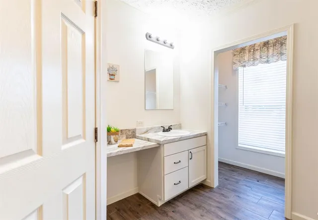 a bathroom with a double vanity sink a mirror and a