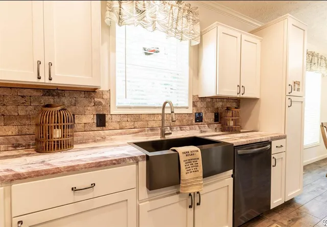 a kitchen with stainless steel appliances granite countertop a sink and a stove