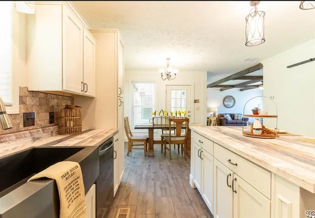 a kitchen with sink cabinets and wooden floor