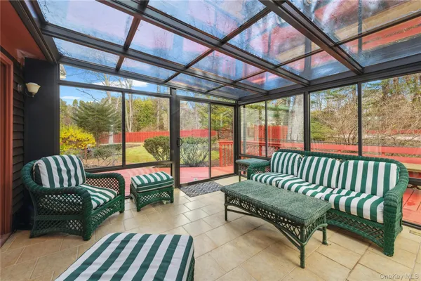 a balcony with furniture and a garden