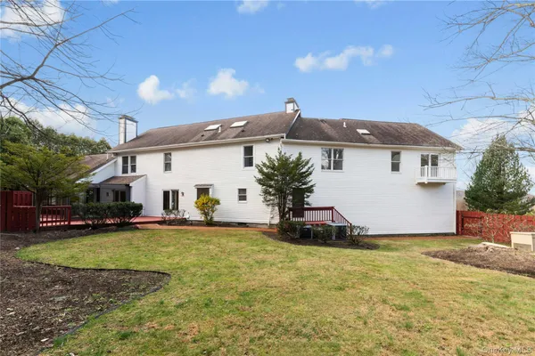 a view of a house with a yard and sitting area
