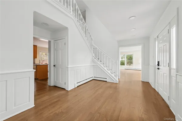 a view of an entryway with wooden floor