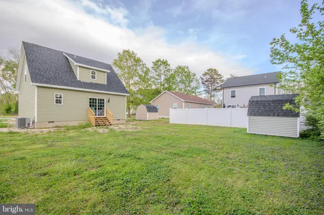 a front view of house with yard and trees