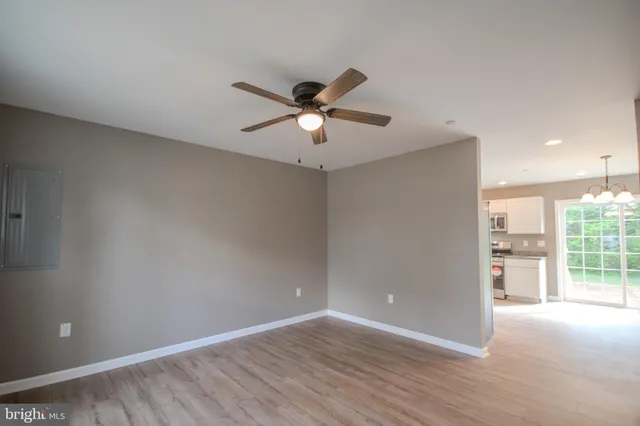 a view of a livingroom with a ceiling fan and window