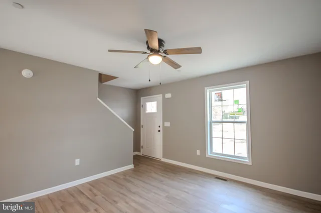 wooden floor in an empty room with a window