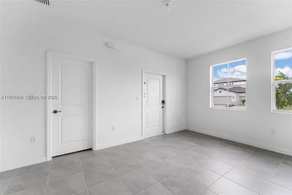 a view of an empty room with windows