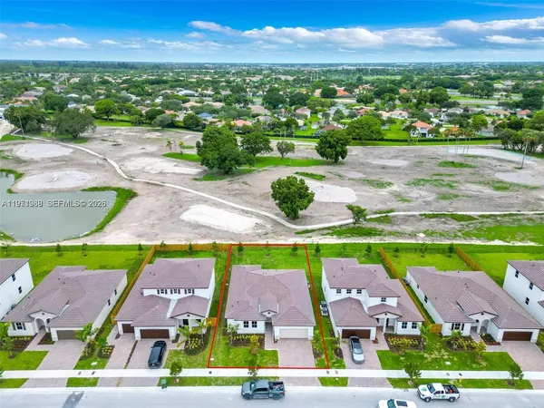 an aerial view of residential houses with outdoor space