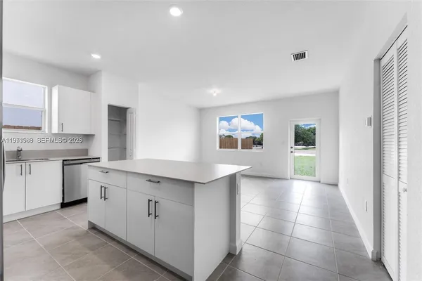a kitchen with a sink cabinets and window
