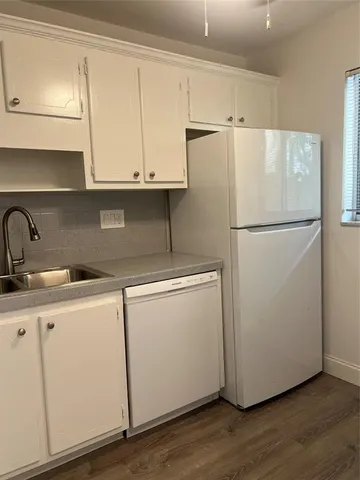 a white refrigerator freezer sitting inside of a kitchen