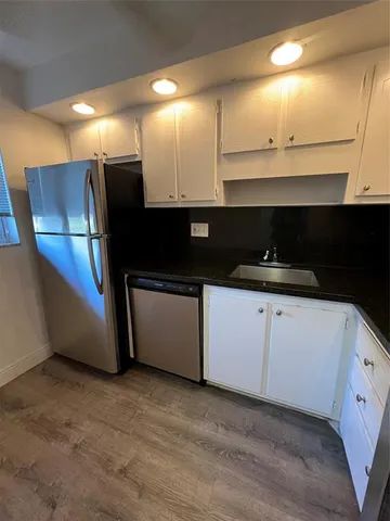a kitchen with stainless steel appliances a refrigerator and cabinets