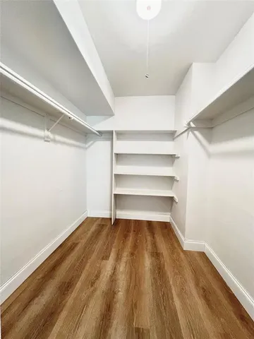 a view of a room with wooden floor
