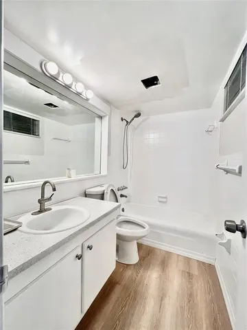a bathroom with a double vanity sink a mirror and a bathtub