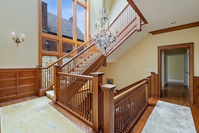 632 West Deming Place Chicago, IL 60614 - Photo 19 of 49 a view of staircase with lots of frames on wall and wooden floor