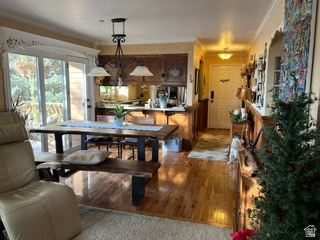 983 Grindelwald Lane, Unit O4 Midway, UT 84049 - Photo 2 of 14 Open-concept living space with wood-finish flooring, a contemporary chandelier, and direct outdoor access through glass sliding doors