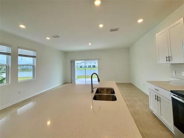 a kitchen with a sink a stove and cabinets