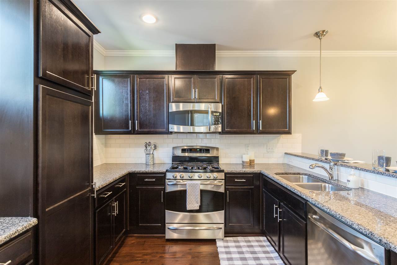 1611 Crafton Way Raleigh, NC 27607 - Photo 10 of 23 Granite counter tops, ample cabinetry, stainless appliances, tiled backsplash, and gas range highlight this kitchen Kitchen