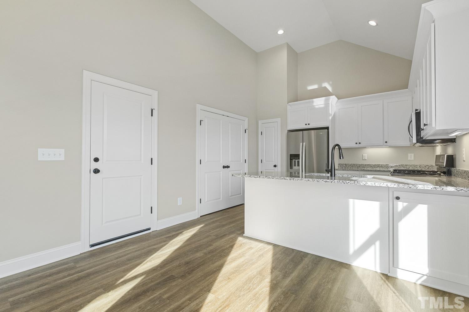 1004 Butler Drive Erwin, NC 28339 - Photo 13 of 38 a large white kitchen with kitchen island a sink stainless steel appliances and cabinets