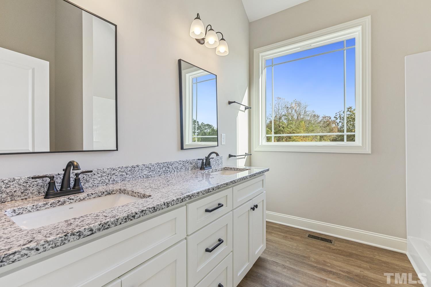 1004 Butler Drive Erwin, NC 28339 - Photo 29 of 38 a bathroom with a granite countertop sink mirror and vanity