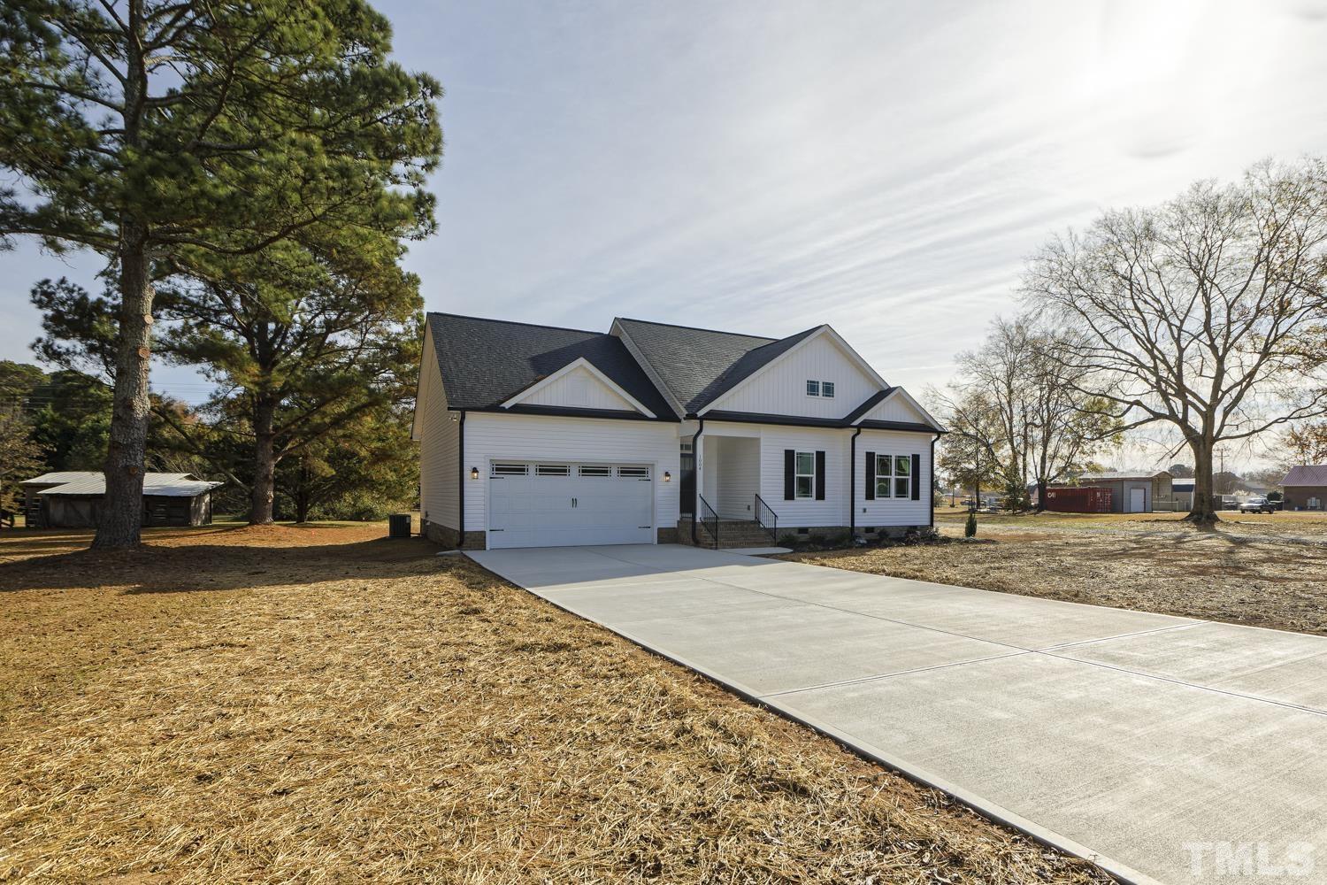 1004 Butler Drive Erwin, NC 28339 - Photo 3 of 38 a house with trees in the background
