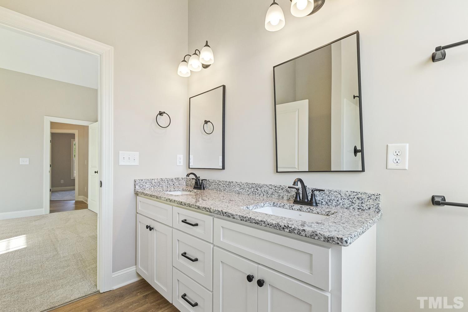 1004 Butler Drive Erwin, NC 28339 - Photo 31 of 38 a bathroom with a granite countertop sink double and mirror