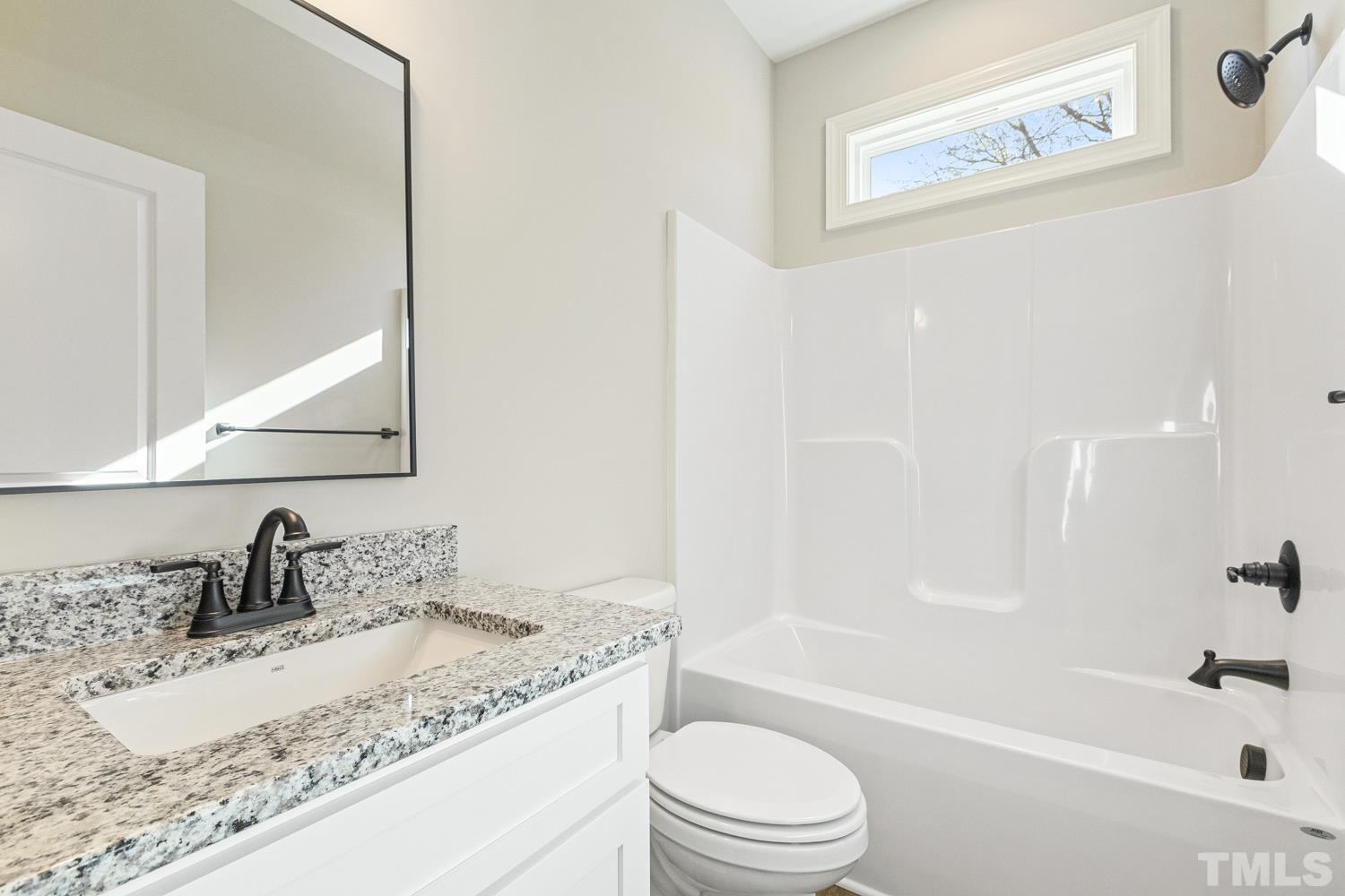 1004 Butler Drive Erwin, NC 28339 - Photo 34 of 38 a bathroom with a granite countertop sink toilet and shower