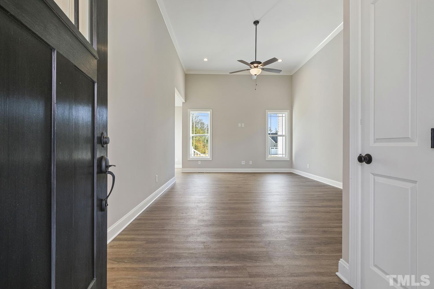 1004 Butler Drive Erwin, NC 28339 - Photo 7 of 38 a view of an empty room with wooden floor and a window