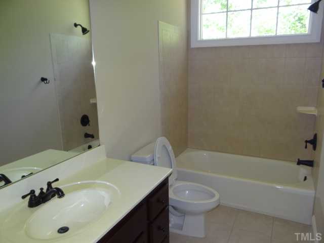 2209 Customs House Court Raleigh, NC 27615 - Photo 11 of 14 a bathroom with a sink a toilet and bathtub