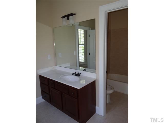 2209 Customs House Court Raleigh, NC 27615 - Photo 13 of 14 a bathroom with a sink and a mirror