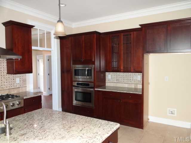 2209 Customs House Court Raleigh, NC 27615 - Photo 7 of 14 a kitchen with stainless steel appliances granite countertop a refrigerator and a sink