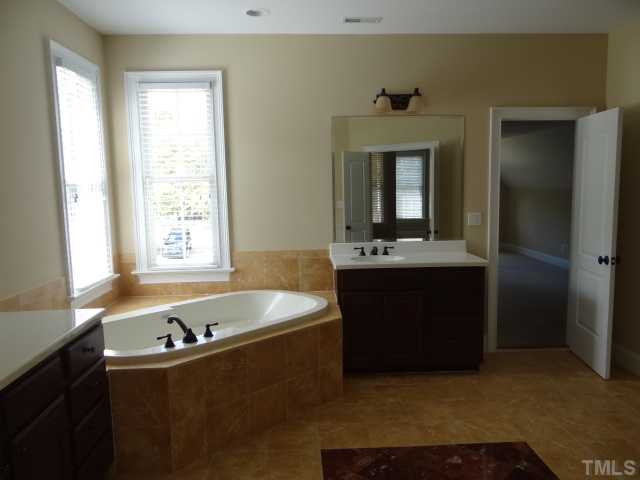 2209 Customs House Court Raleigh, NC 27615 - Photo 9 of 14 a bathroom with a bathtub and a sink