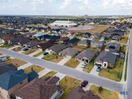 an aerial view of residential houses with outdoor space