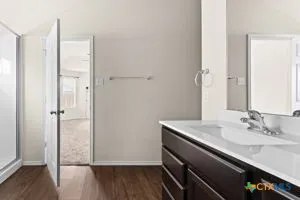 a bathroom with a sink a vanity and a mirror
