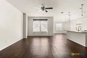 a view of a kitchen with wooden floor and a ceiling fan