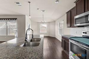 210 Highmore Court Temple, TX 76502 - Photo 6 of 15 a kitchen with granite countertop a sink stainless steel appliances and cabinets