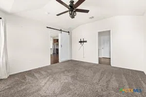a view of a room with a ceiling fan