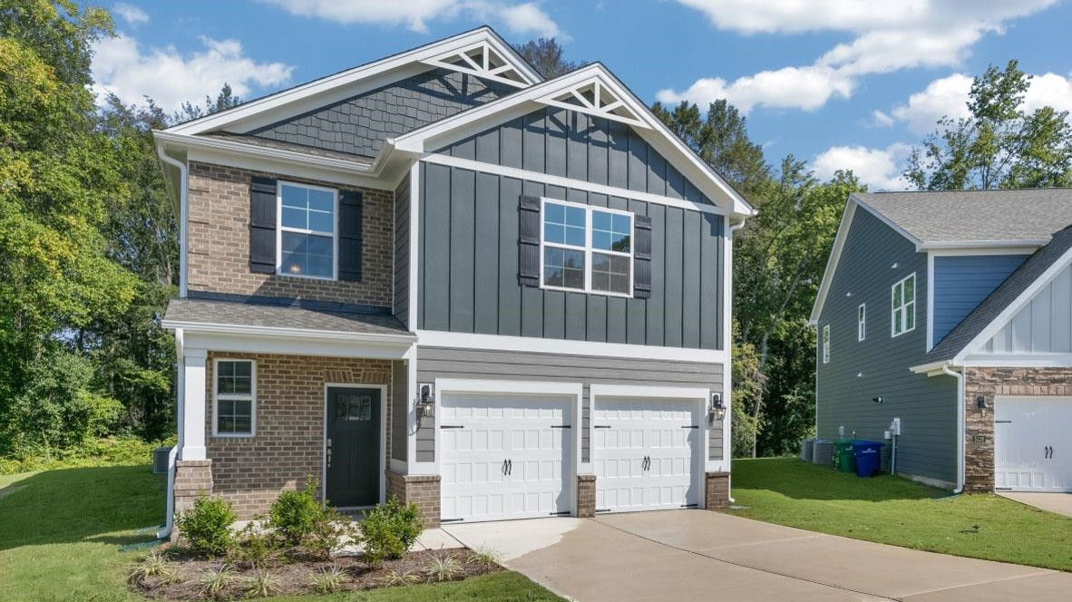 a front view of a house with a yard and garage