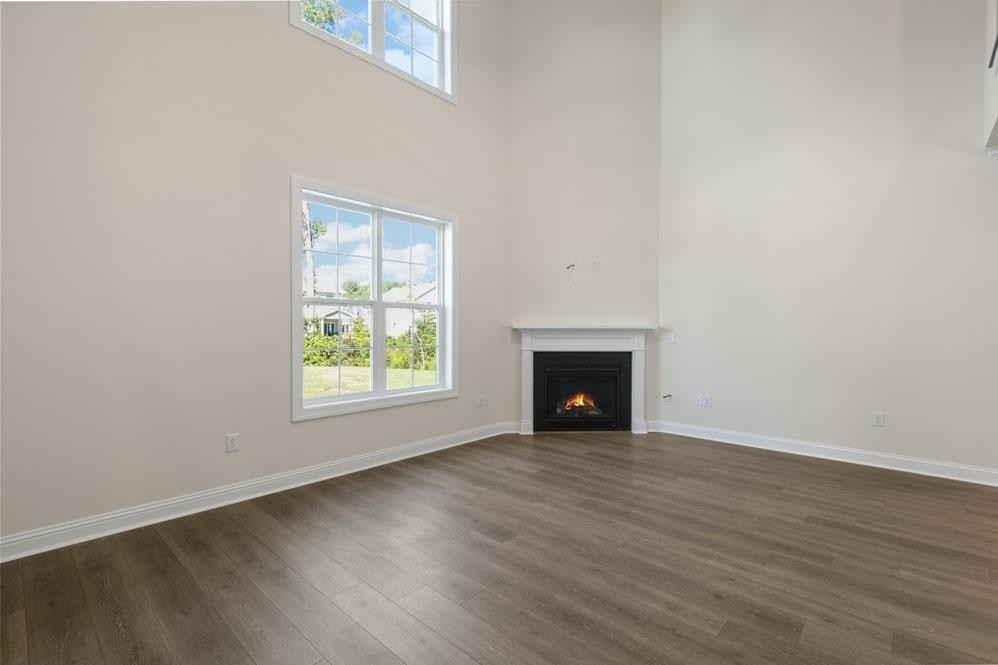 5129 Lizard Tail Lane Raleigh, NC 27603 - Photo 11 of 49 an empty room with wooden floor and windows