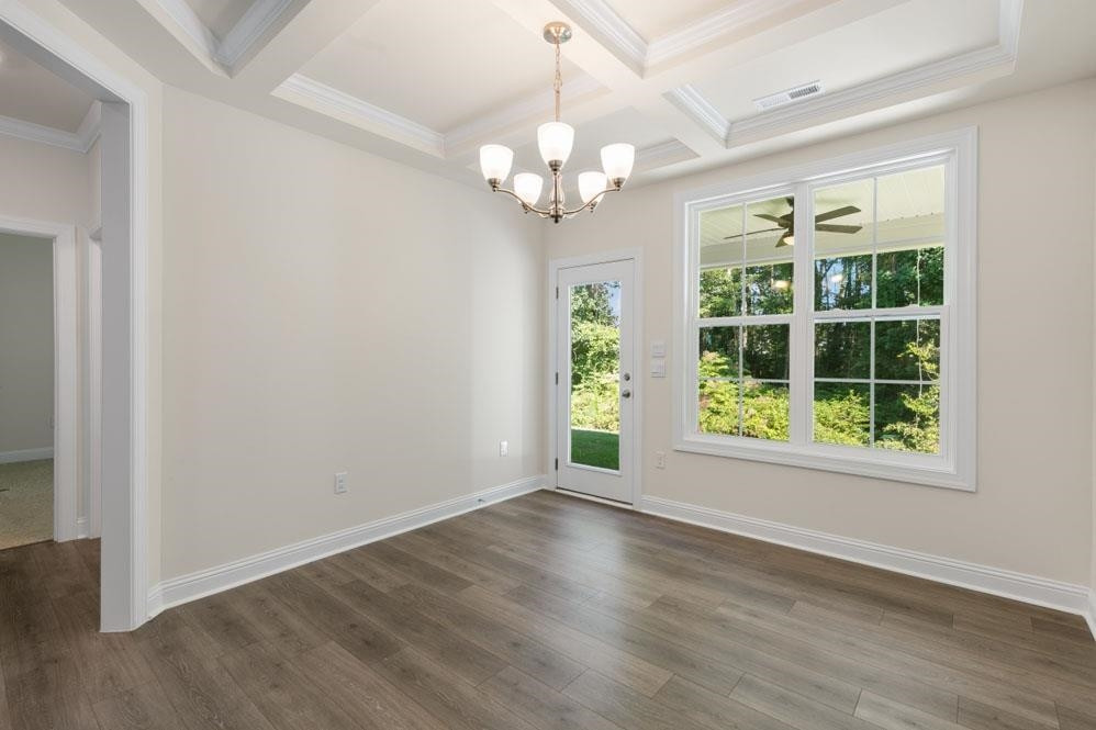 5129 Lizard Tail Lane Raleigh, NC 27603 - Photo 15 of 49 a view of an empty room with wooden floor and a window