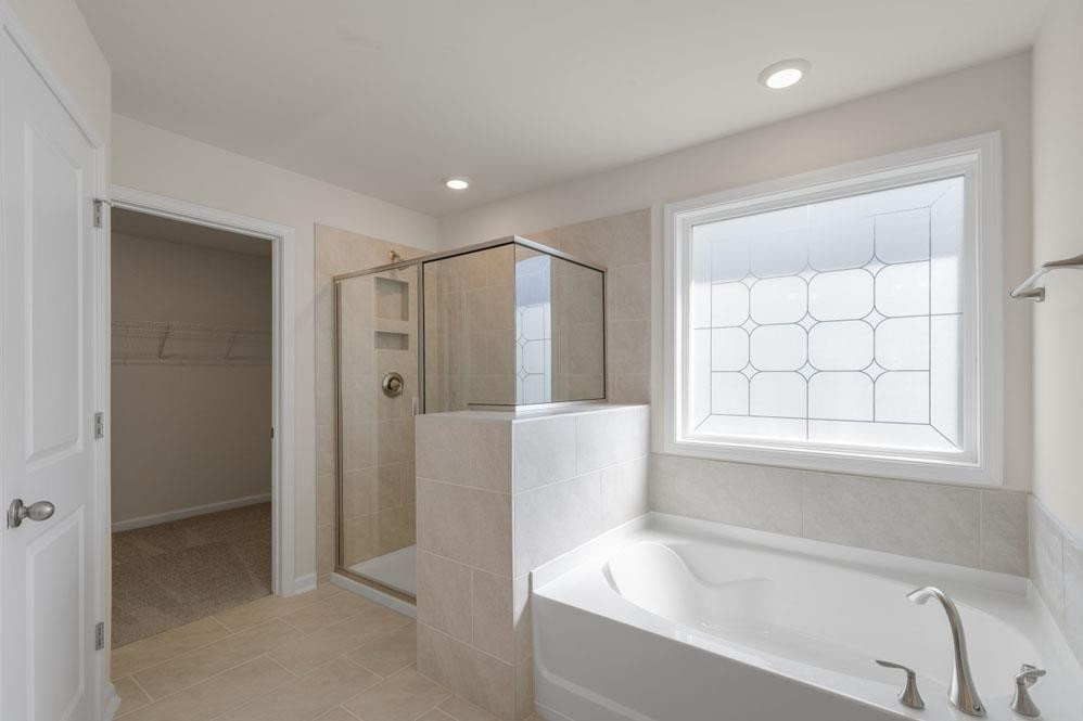 5129 Lizard Tail Lane Raleigh, NC 27603 - Photo 20 of 49 a bathroom with a bathtub and a shower